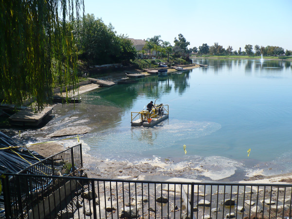 dino six being used to dredge homeowners assocation lake